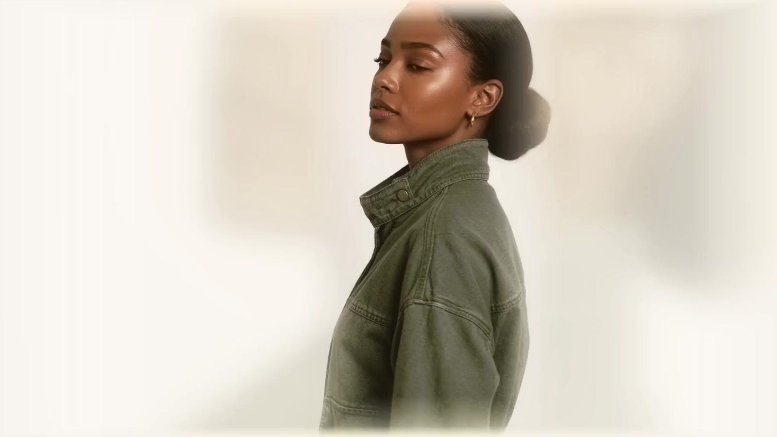 A model wearing the Utility Jacket, photographed full length in a cream studio