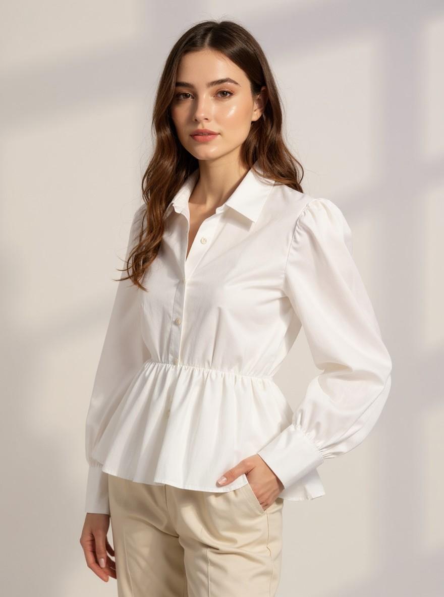 The Collar Shirt in White, three-quarter view showing the gathered puff sleeve and pin-tucked peplum waist
