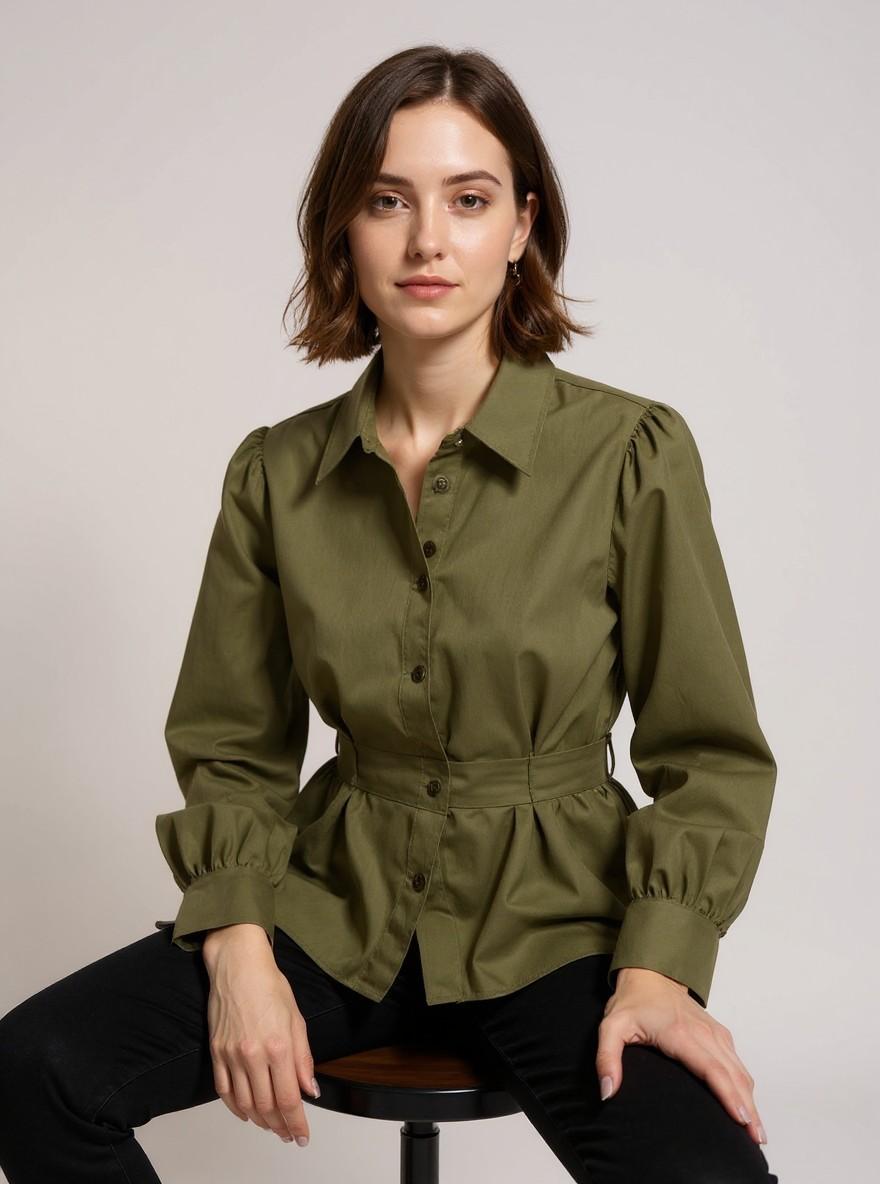 The Collar Shirt in Khaki, seated on a stool, front view