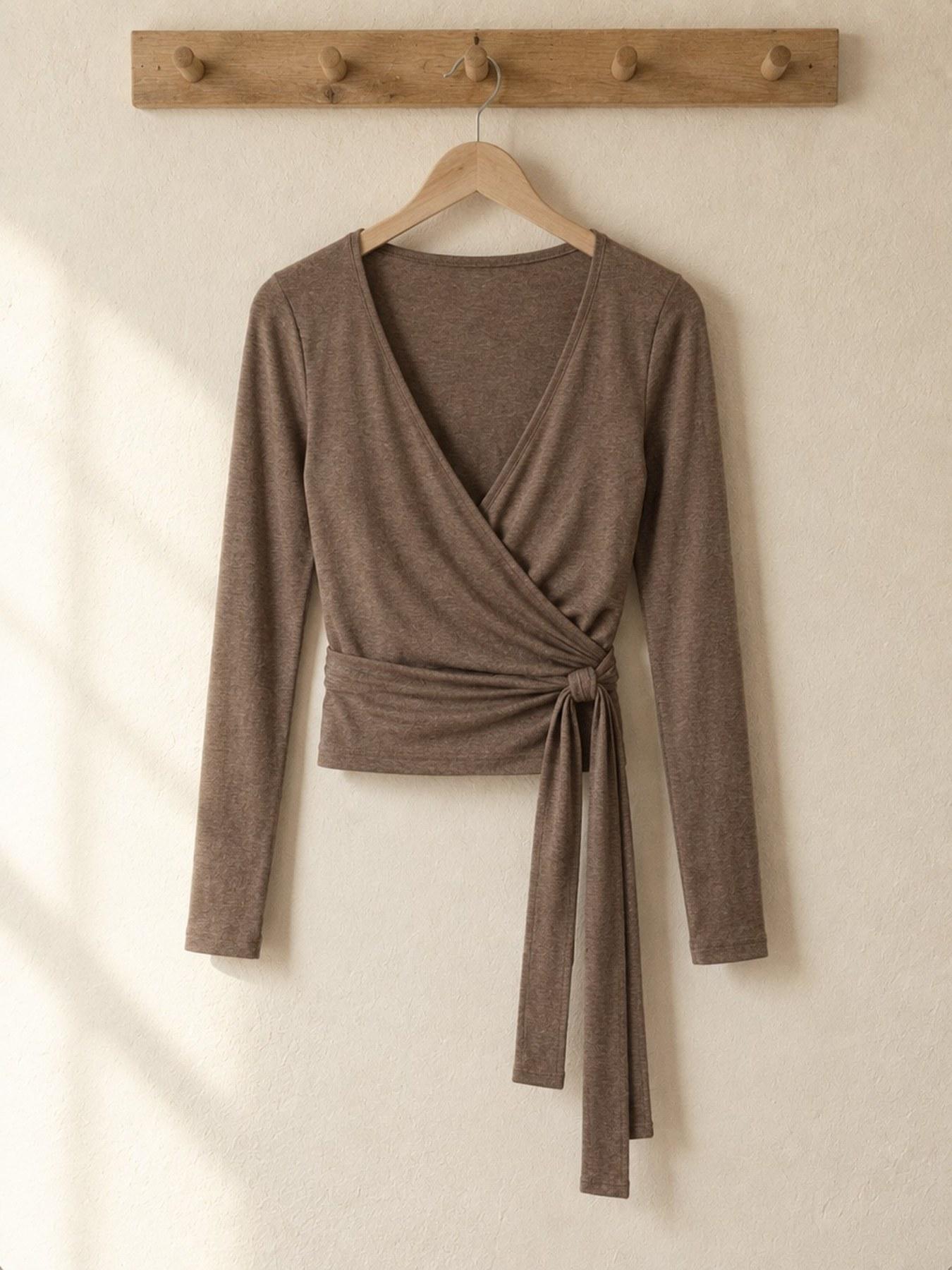 The Wrap Top in Taupe, on the hanger