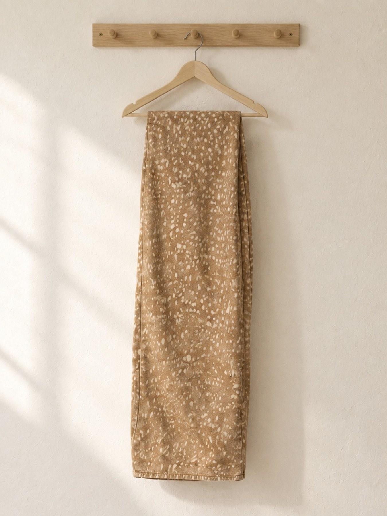 The Fawn Trouser in Beige, on the hanger