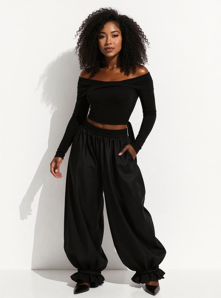 The Parachute Trouser in Black, front view, full length in studio