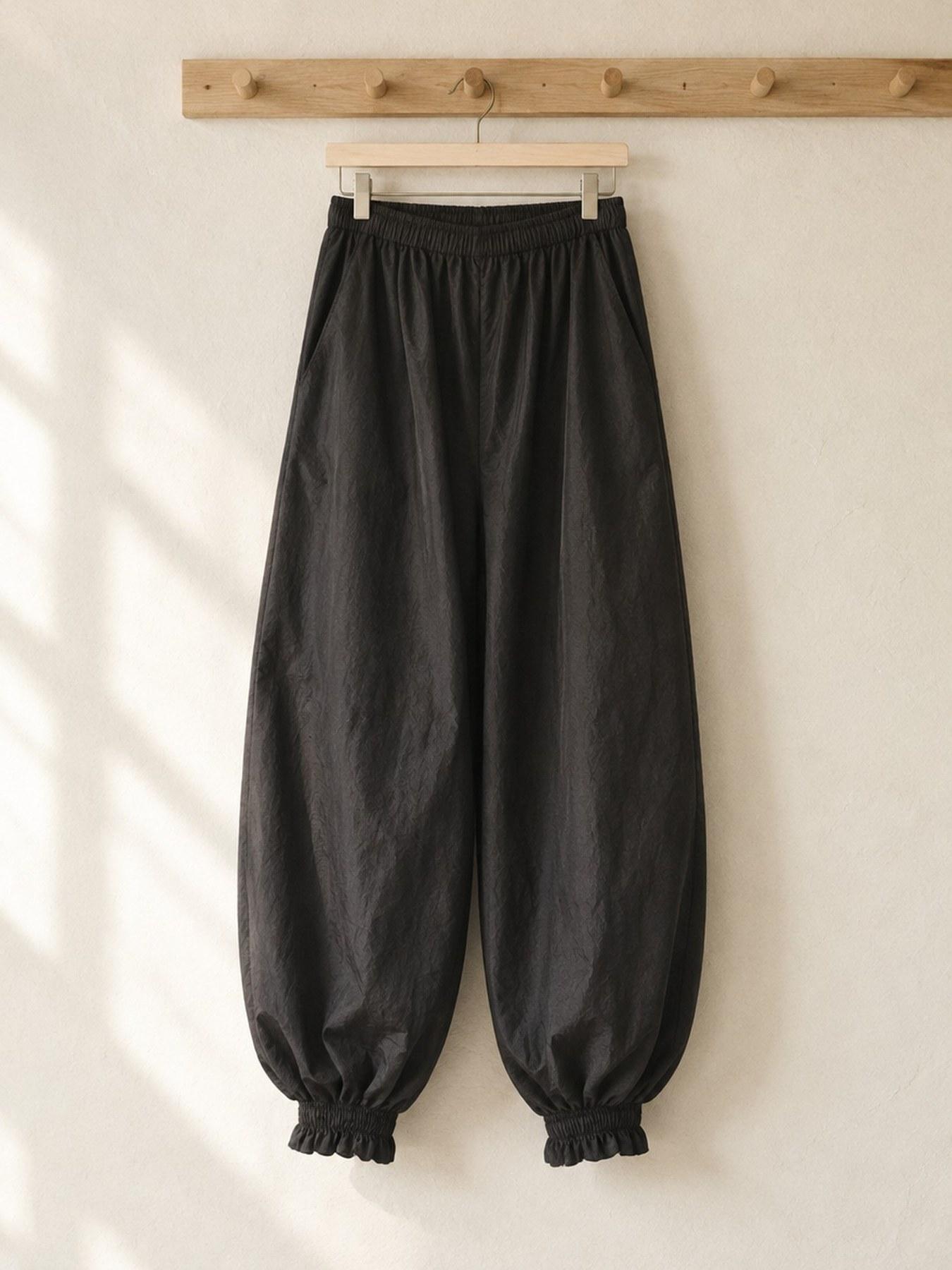 The Parachute Trouser in Black, on the hanger